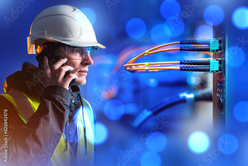 Employee of telecommunication company. Man worker with phone. Internet provider. Guy works for telecommunications company. Engineer man makes call. Telecommunication equipment with wires