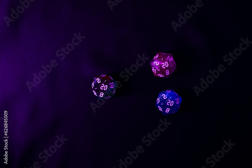 blue and pink colour dices for fantasy dnd and rpg tabletop games. Board game polyhedral dices with different sides isolated on black background