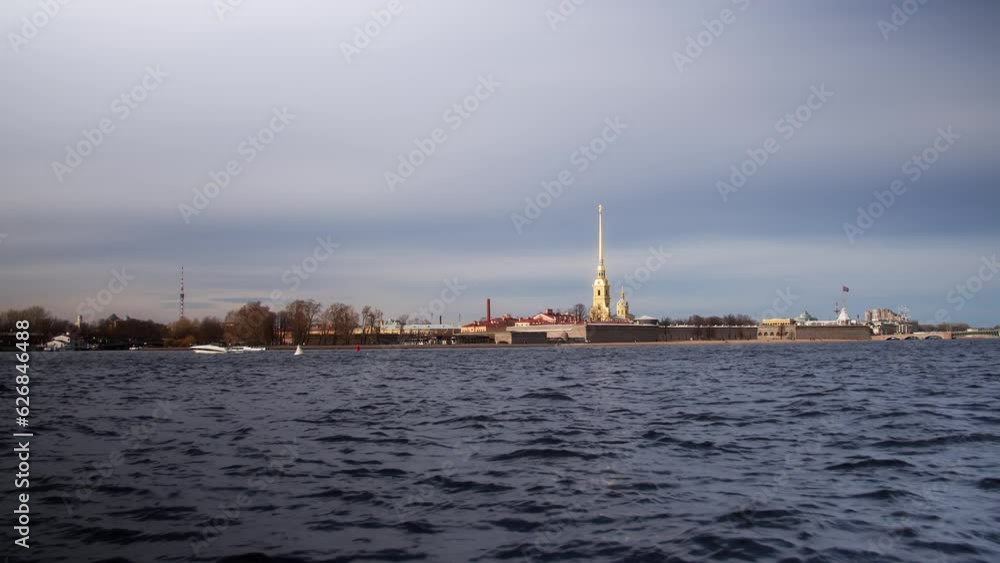 Peter and Paul Fortress in St. Petersburg, Russia. The golden spire of the cathedral, the fortified stone walls, the flag of the Russian Navy. View from the Neva River on a sunny day. High quality 4k Peter and Paul Fortress in St. Petersburg, Russia. The golden spire of the cathedral, the fortified stone walls, the flag of the Russian Navy. View from the Neva River on a sunny day. High quality 4k