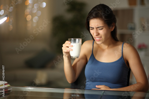 Woman suffering lactose intolerance after drinking milk photo