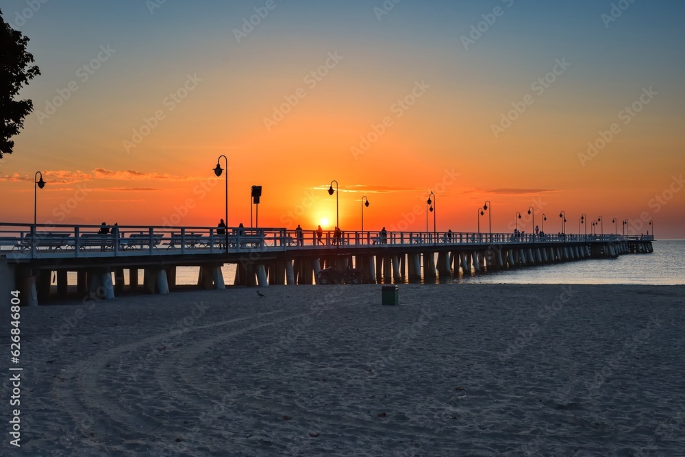 Colorful seaside morning landscape. Wooden pier on the sea at sunrise. Photo taken in Gdynia Orlowo on the Baltic Sea in Poland.