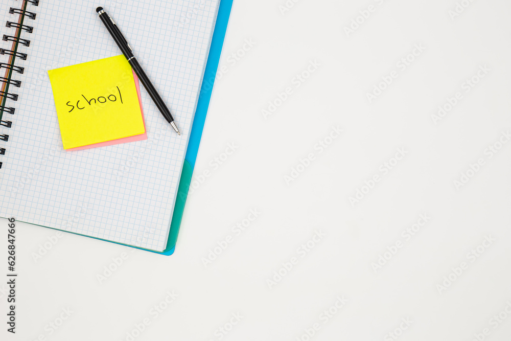 Notebook, pen and paper colored reminders on a white background. Notebook, pen and paper colored reminders on a white background.