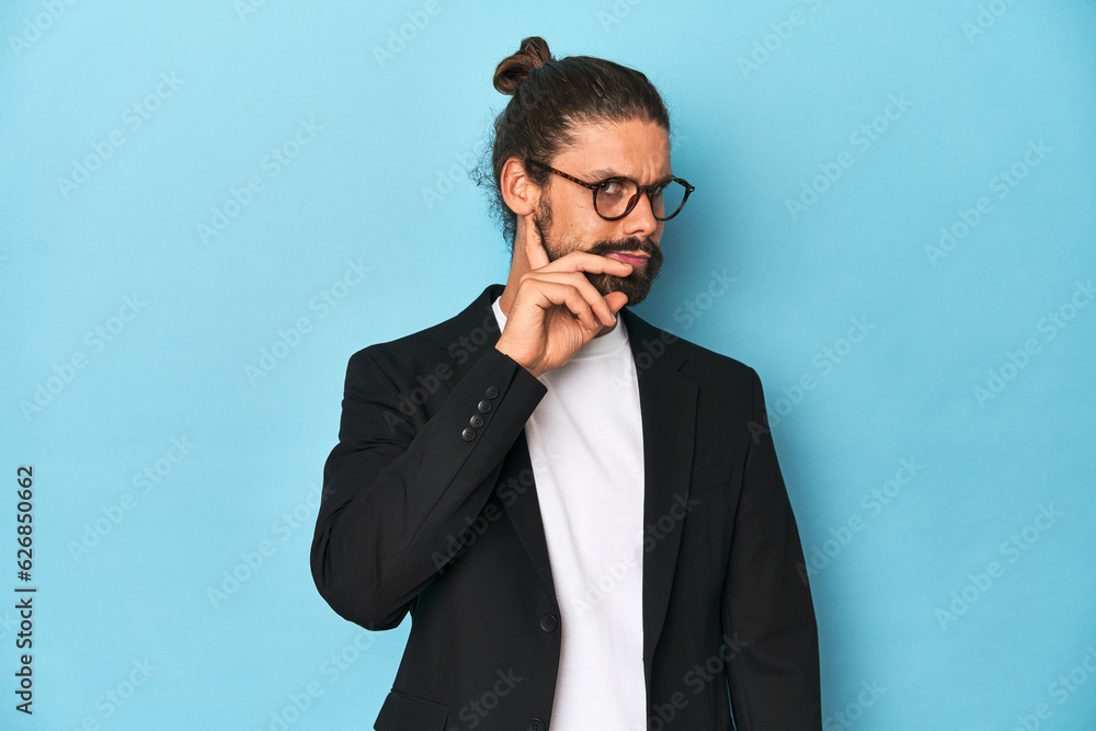 Businessman in suit with eyeglasses and beard trying to listening a gossip. Businessman in suit with eyeglasses and beard trying to listening a gossip.