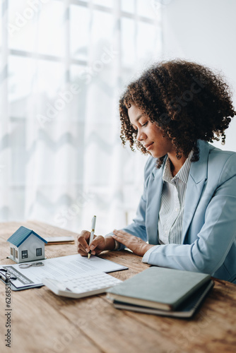 Guarantee, Mortgage, agreement, contract, Signing,woman african american client holding pen to reading agreement document to sign land loan with real estate agent or bank officer, insurance concepts
