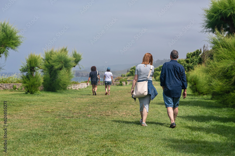 Couples walking along the Promenade San Pedro, Llanes. Asturias Couples walking along the Promenade San Pedro, Llanes. Asturias