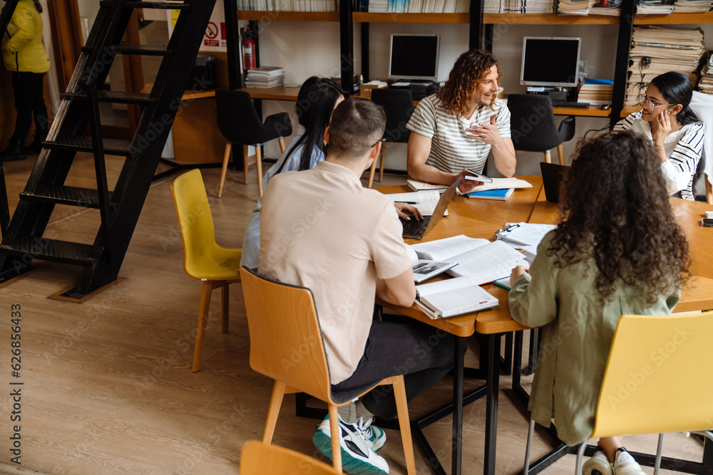Group of students studying together in library