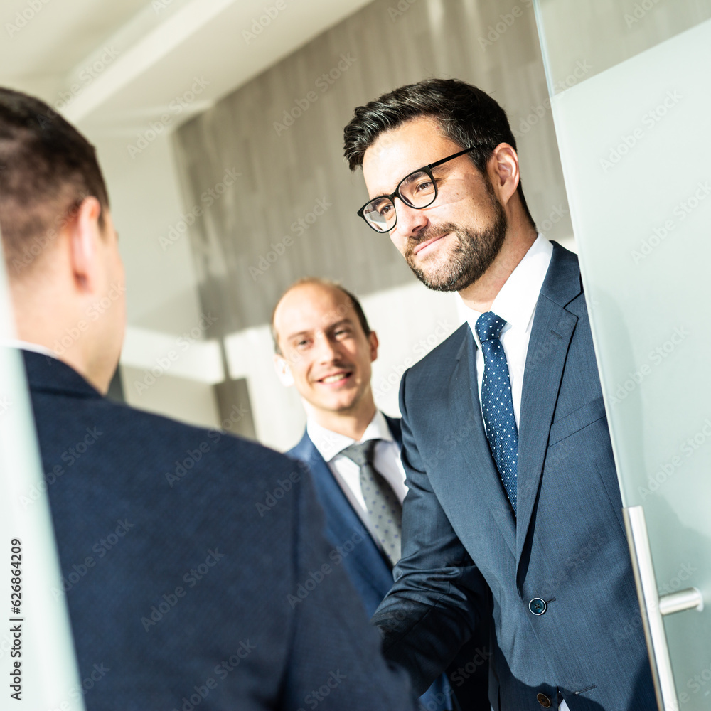 Group of confident business people greeting with a handshake at business meeting in modern office. Closing the deal agreement by shaking hands. Business and entrepreneurship success concept. Group of confident business people greeting with a handshake at business meeting in modern office. Closing the deal agreement by shaking hands. Business and entrepreneurship success concept.