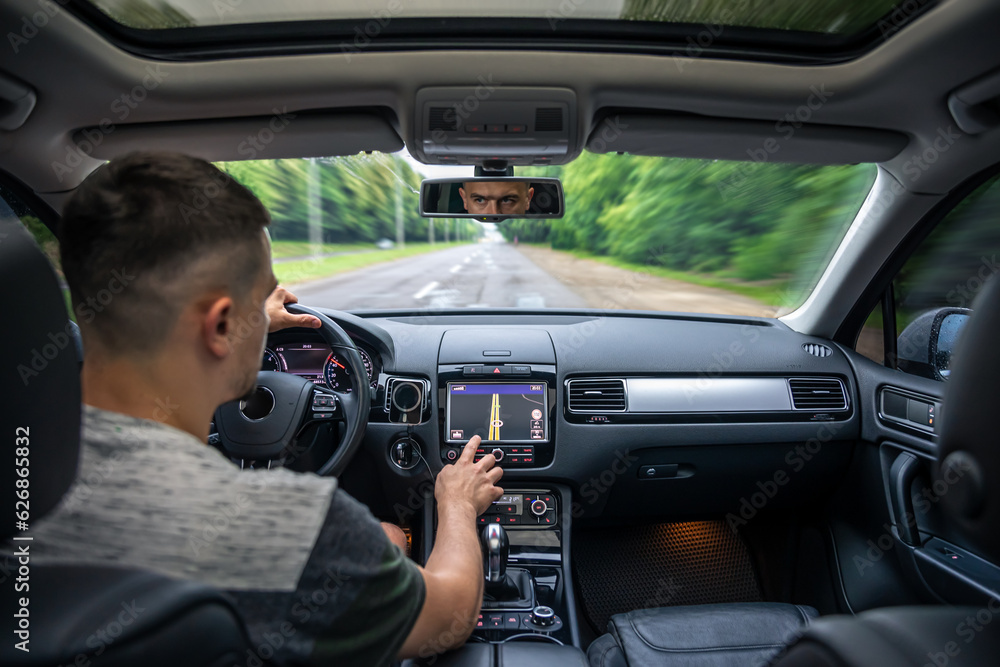 Man touching screen of a GPS navigation system in his car. Man touching screen of a GPS navigation system in his car.
