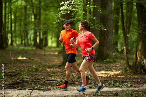 Running couple in the forest © Xalanx