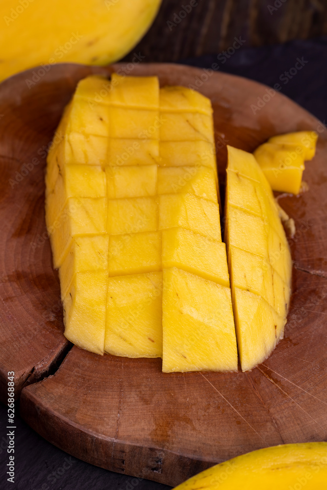 sliced ripe mango fruit on a board, close-up