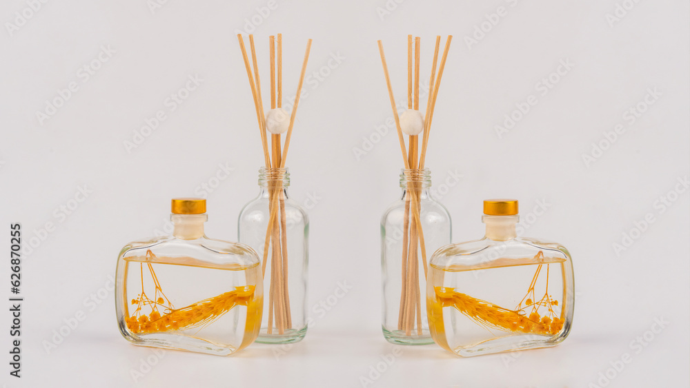 Reed diffuser bottle on the podium. Incense sticks for the home on white Reed diffuser bottle on the podium. Incense sticks for the home on white