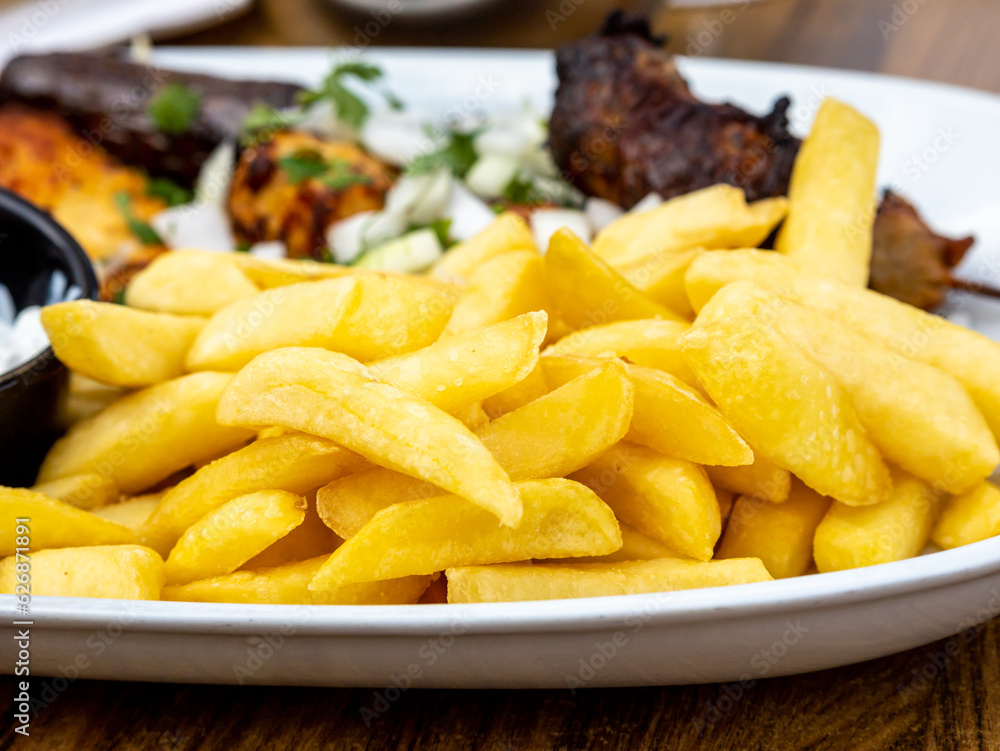 Fried potatoes with gravy and fried sausages Fried potatoes with gravy and fried sausages