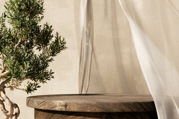 Natural wooden table and organic cloth with olive tree plant. Product placement mockup design background. Outdoor tropical summer scene with rustic vintage countertop display.