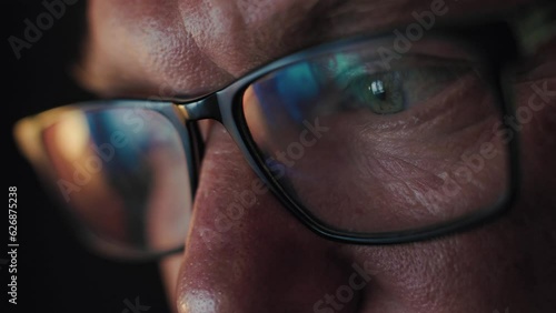 Close-up of a focused adult serious man in glasses
