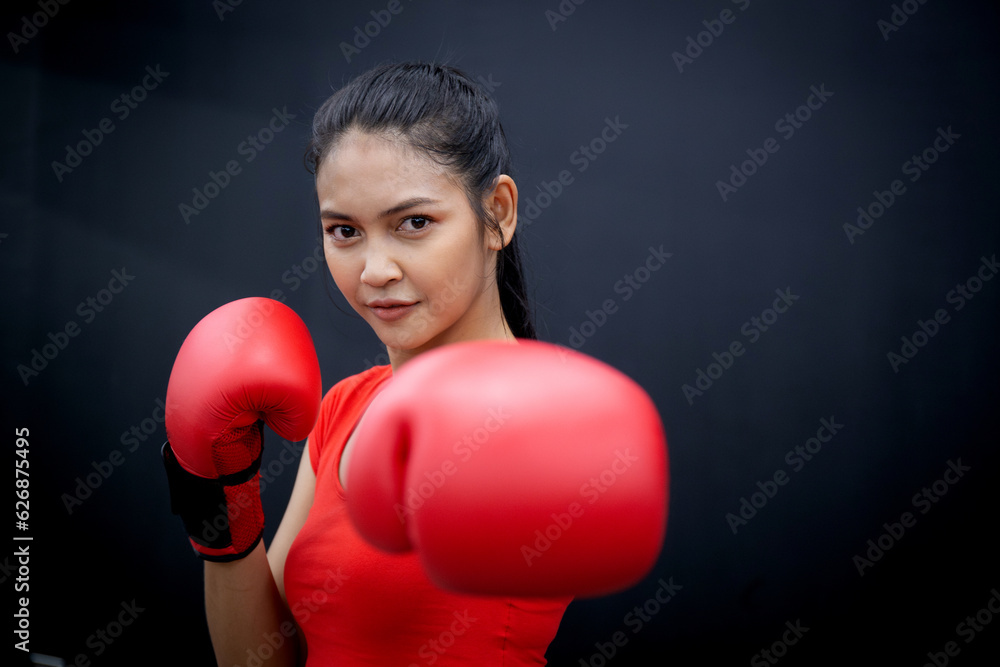 Determination of young asian woman having motivation boxing in fitness gym, active sport and workout, training boxing with strength and confidence, health and wellness, exercise and punch with cardio. Determination of young asian woman having motivation boxing in fitness gym, active sport and workout, training boxing with strength and confidence, health and wellness, exercise and punch with cardio.