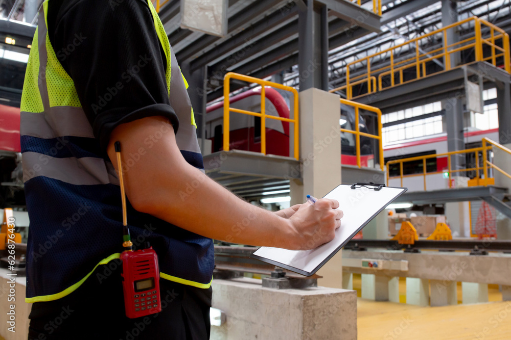Checking Engineering Document Closeup hands young engineer man or worker checking electric train for ...