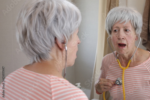 Tableau sur toile Senior woman doing a self medical diagnostic