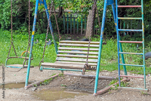 Empty children's swing on a summer day