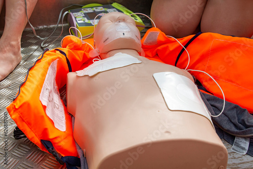 CPR manikin with AED pads on the chest