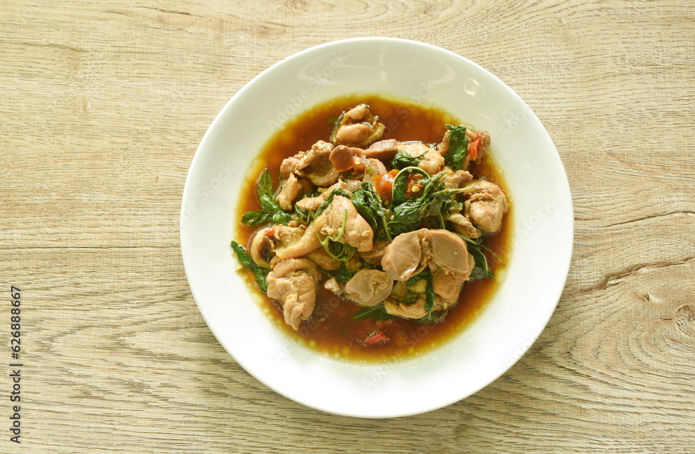 spicy stir-fried chili chicken meat and gizzard with basil on plate spicy stir-fried chili chicken meat and gizzard with basil on plate