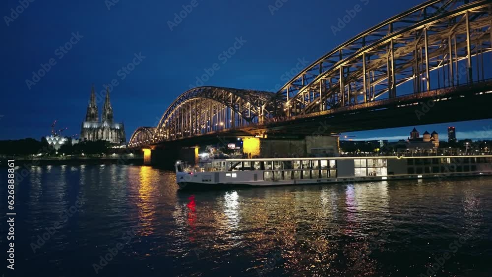 Boat traffic with background of bridge and the Dom of Cologne at night. Germany Boat traffic with background of bridge and the Dom of Cologne at night. Germany