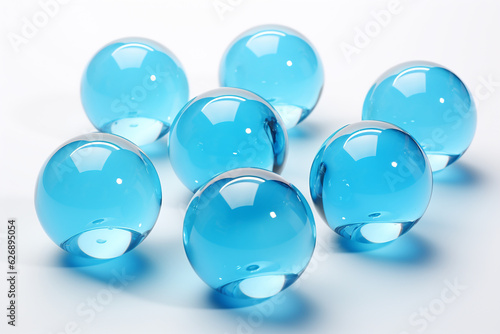 Decorative round glass blue balls marbles on white background.