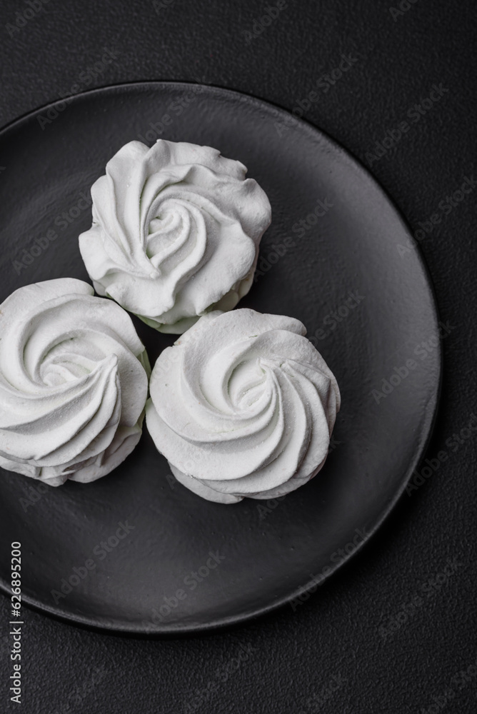 Delicious sweet colored marshmallow on a dark concrete background Delicious sweet colored marshmallow on a dark concrete background