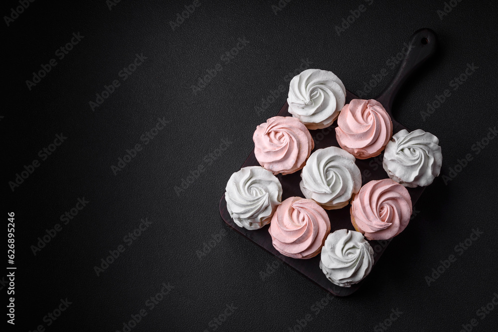 Delicious sweet multi-colored marshmallow on a dark concrete background Delicious sweet multi-colored marshmallow on a dark concrete background
