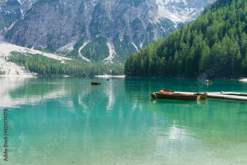 The lake is clear, sometimes green, sometimes blue, and surrounded by mountains. Nature's Wonderland: Lake Braies and its Captivating Alpine Scenery. © twabian