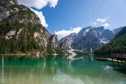 The lake is clear, sometimes green, sometimes blue, and surrounded by mountains. Nature's Wonderland: Lake Braies and its Captivating Alpine Scenery.