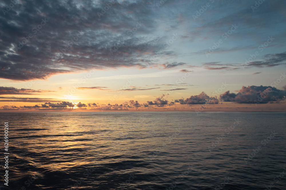 Peaceful sunset in the middle of the ocean on board of a cruise ship.