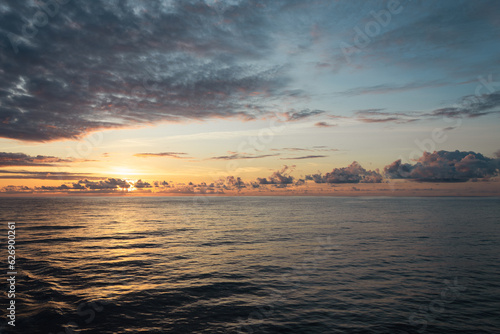 Peaceful sunset in the middle of the ocean on board of a cruise ship.