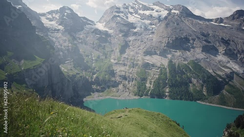 View of Oeschinensee Oeschinen Lake alpine lake with cliffs and snowy peaks above