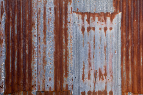 Old rusty zinc fence wall surface grunge, vintage style metal sheet roof for texture and background in retro concept