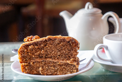 Obraz na płótnie A slice of coffee and walnut cake, with a shallow depth of field