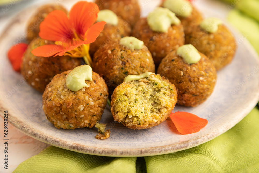 Falafel with guacamole on white concrete. Side view, selective focus. Falafel with guacamole on white concrete. Side view, selective focus.