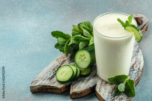 ayran drink with mint and cucumber on a white background, clean eating for weight loss. place for text photo