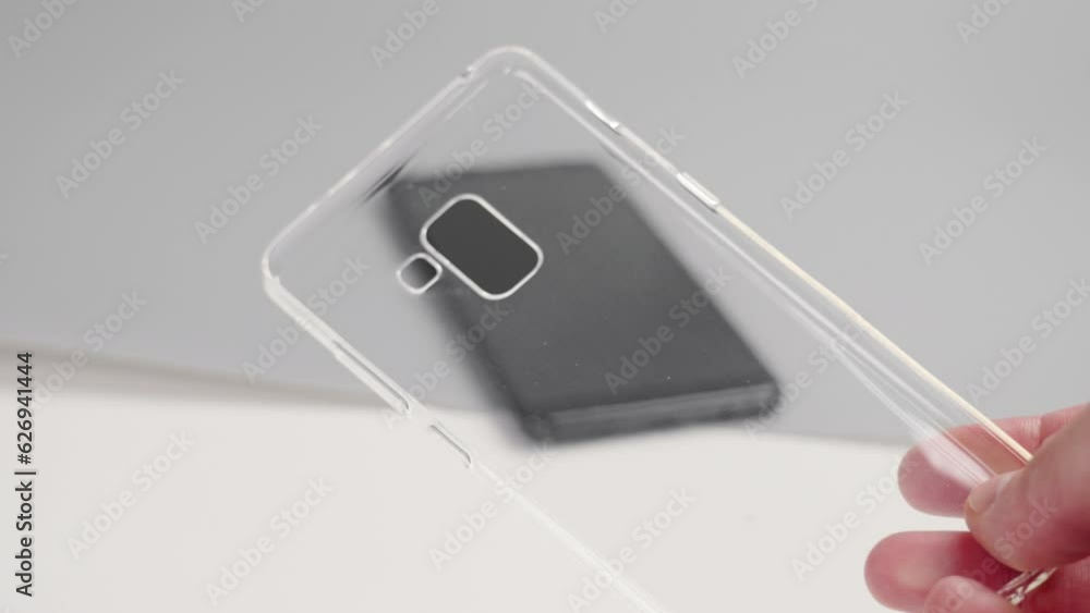 Protective silicone transparent smartphone case in hand. New cell phone accessory Protective silicone transparent smartphone case in hand. New cell phone accessory