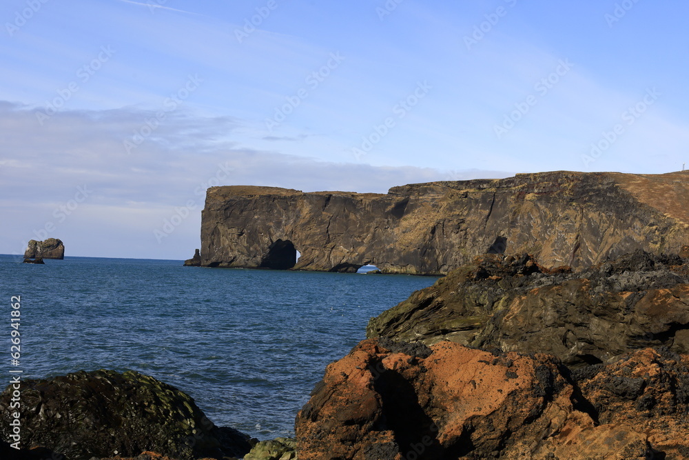 View on Dyrhólaey formerly known by seamen as Cape Portland which is a small promontory located on the south coast of Iceland, not far from the city of Vik.