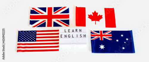 Flags of Canada, USA, Great Britain and Australia in the middle of the inscription we learn English. Language conversation club.