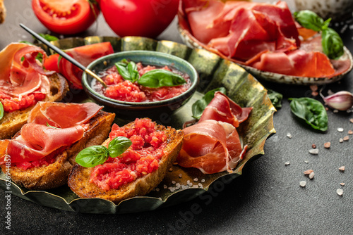 tomato toast with oil, jamon and tomato, traditional Spanish breakfast or lunch. Concept healthy and balanced eating. place for text, top view photo