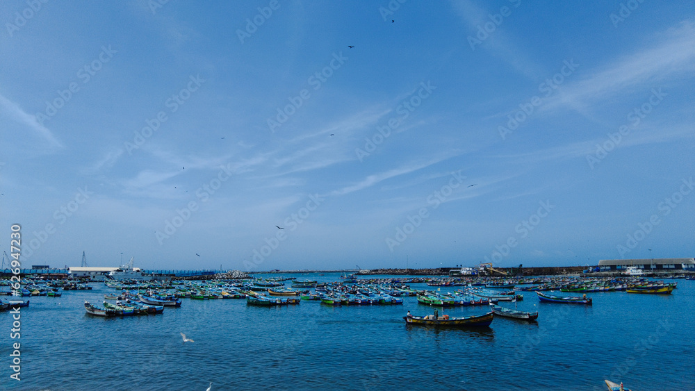 Vizhinjam fishing harbor, Thiruvananthapuram, Kerala, bright blue sky, seascape view