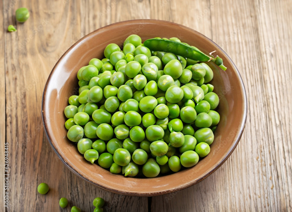 fresh peas in a bowl with wooden background