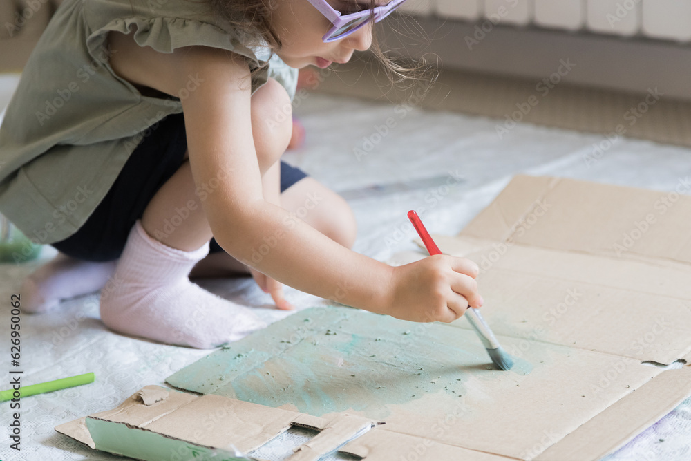 Sweet little girl playing with paints. Child exploring his creativity by painting with watercolors in a home environment. Sweet little girl playing with paints. Child exploring his creativity by painting with watercolors in a home environment.