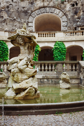 Prague, Czech Republik - June 23, 2023: Statue of Neptune, Grotta fountain in Grebovka, Havlicek Gardens, Havlickovy zahrady, Praha, Czechia - Sculpture of mythical god. High quality photo photo