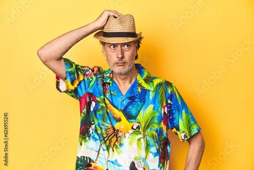 Middle-aged man in Hawaiian shirt and straw hat Middle-aged man in Hawaiian shirt and straw hatbeing shocked, she has remembered important meeting.