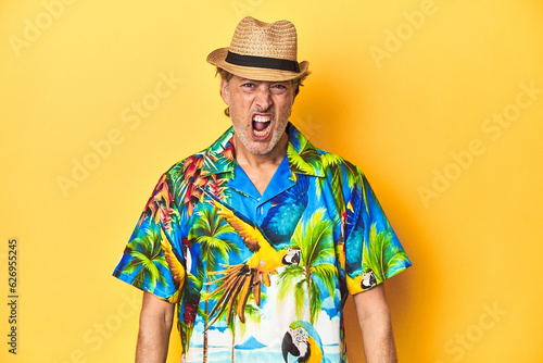 Middle-aged man in Hawaiian shirt and straw hat Middle-aged man in Hawaiian shirt and straw hatscreaming very angry and aggressive.
