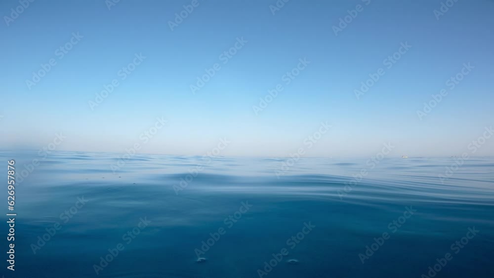 Swimmer passing During Calm Ocean At Summer Golden Hour Time Swimmer passing During Calm Ocean At Summer Golden Hour Time