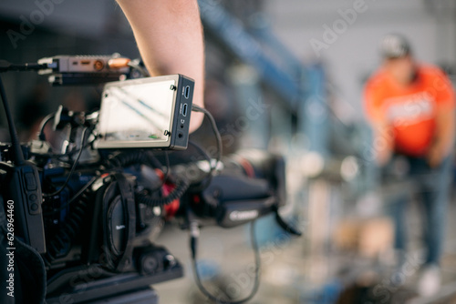 A professional film and video camera on the set. Filming day, equipment and crew. Technique of modern video filming.