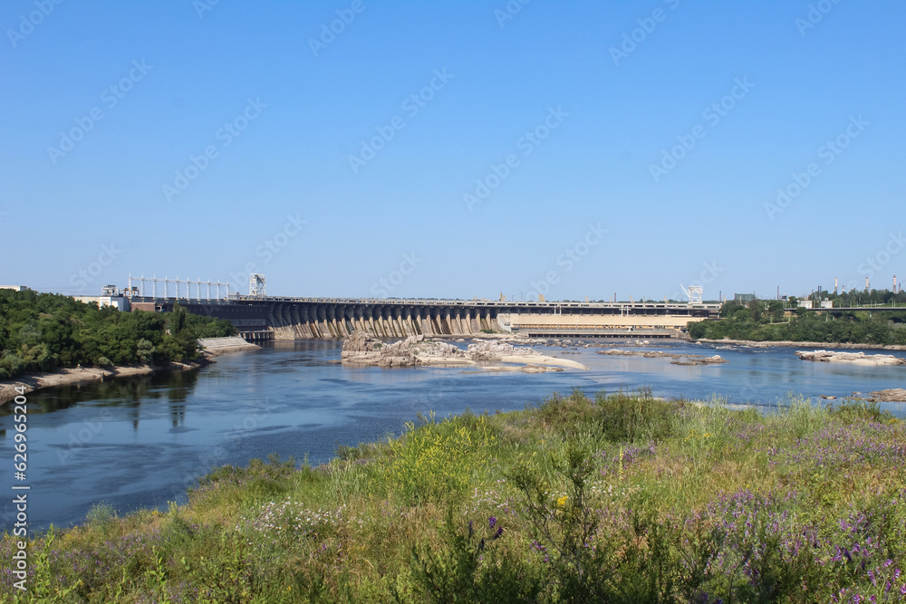 Dnipro river, Zaporizhzhia, Ukraine. Dniproges, Dnipro hydroelectric station, dam. Hydroplant, construction, cityscape. Shallowing of water. Khortytsia island. Dnipro rapids.